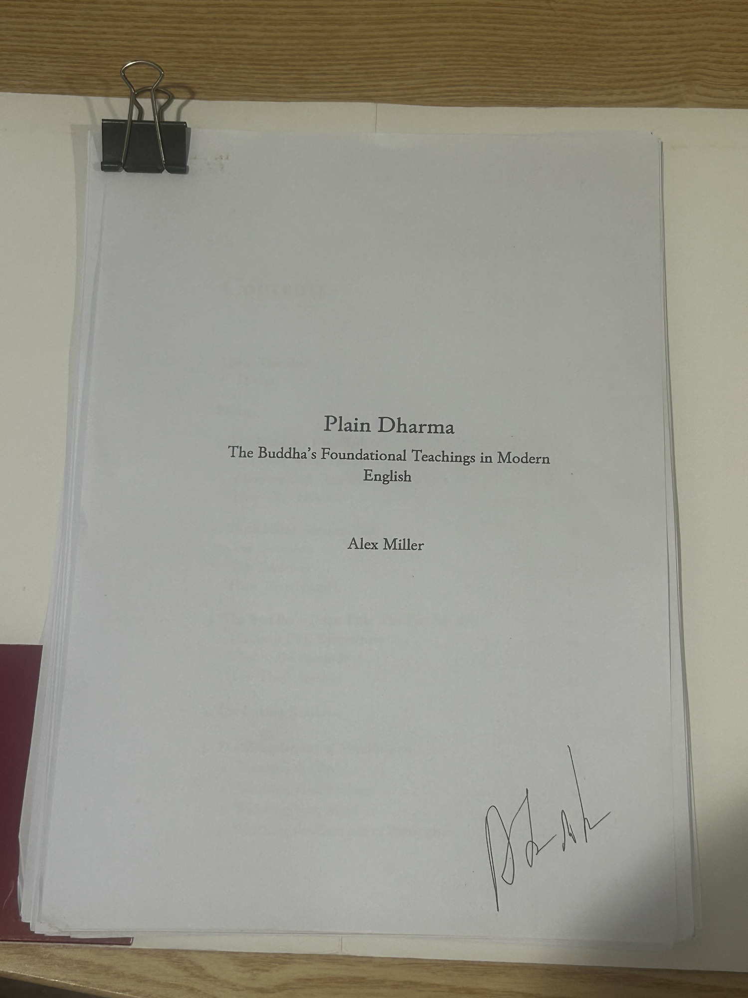 The signed printed proof of Plain Dharma — title page on top, held with a binder clip.